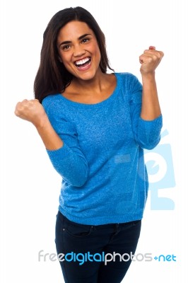 Excited Pretty Girl With Clenched Fists Stock Photo