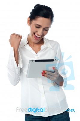 Excited Pretty Woman Using Tablet Pc Stock Photo