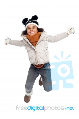 Excited Primary Girl Jumping With Joy Stock Photo