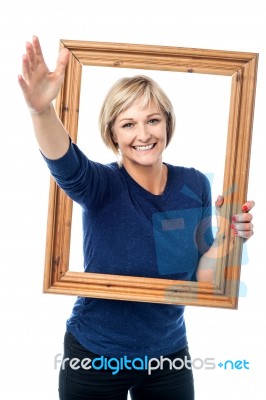 Excited Woman Holding Picture Frame Stock Photo