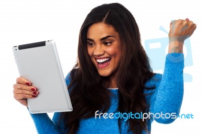 Excited Woman Holding Touch Pad Stock Photo