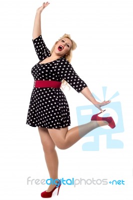 Excited Woman Posing In One Leg Stock Photo