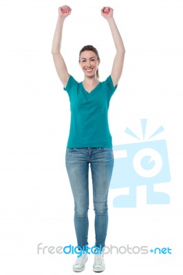 Excited Woman Raising Her Arms Up Stock Photo