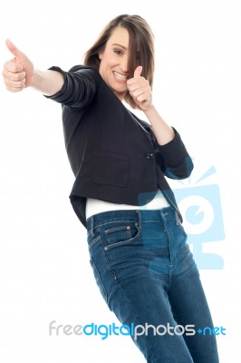 Excited Woman Showing Thumbs Up Gesture Stock Photo