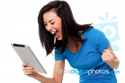 Excited Young Girl Holding Touch Pad Device Stock Photo