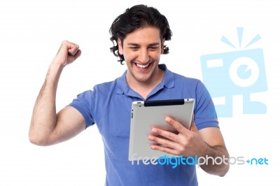 Excited Young Man Holding Touch Pad Device Stock Photo