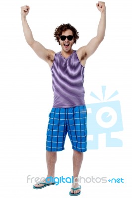 Excited Young Man Raising His Arm Stock Photo