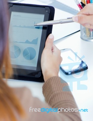 Executive Hands With Digital Tablet In A Financial Meeting Stock Photo