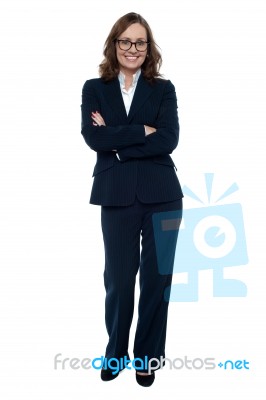 Executive In Business Attire Standing Arms Folded Stock Photo