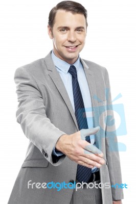 Executive Welcoming You With A Handshake Stock Photo