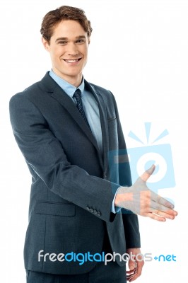 Executive Welcoming You With A Handshake Stock Photo