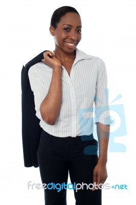 Executive With Coat Slung Over Her Shoulder Stock Photo