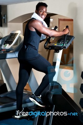 Exercising African Male In Gym Stock Photo