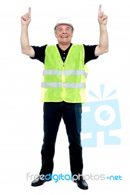 Experienced Construction Employee Pointing His Fingers Upwards Stock Photo