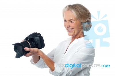 Experienced Female Photographer With Camera Stock Photo