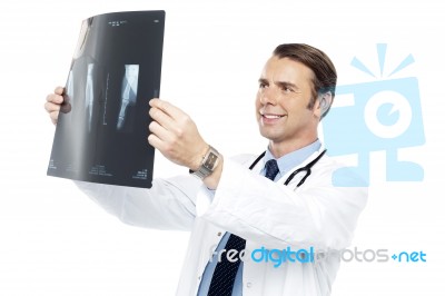 Experienced Orthopedic Surgeon Reviewing X-ray Report Stock Photo