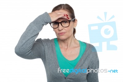 Expressionless Woman Looking At Distance Object Stock Photo