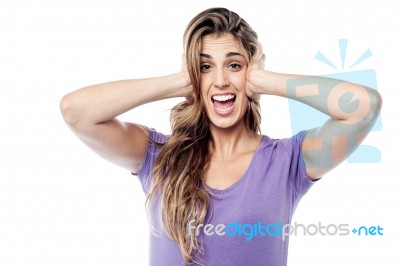 Expressive Woman Covering Her Ears Stock Photo