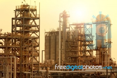 Exterior Tube Of Petrochemical Plant And Oil Refinery For Produce Industrial Material In Heavy Petroleum Industry Estate Against Beautiful Sun Light Sky Stock Photo