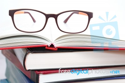 Eyeglasses On Book Stacks Stock Photo