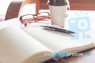 Eyeglasses With Coffee Cup In Coffee Shop Stock Photo