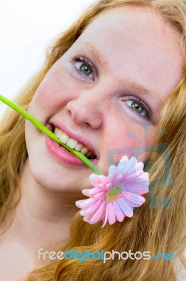 Face Of Girl With Pink Flower In Her Mouth Stock Photo