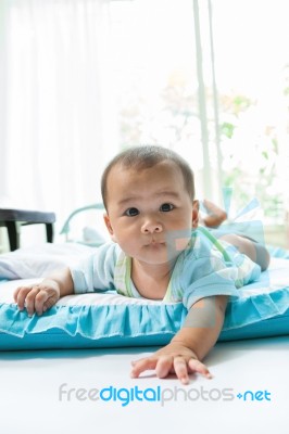 Face Of Little Baby Lying On Children Bed In Home Living Room Stock Photo