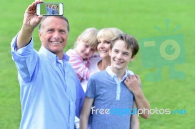 Family Capturing Their Enjoyment Stock Photo