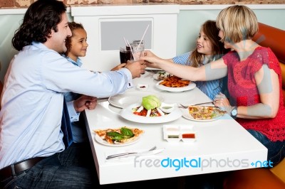 Family Dinner At Restaurant Stock Photo