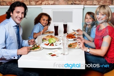 Family Eating Together In A Restaurant Stock Photo