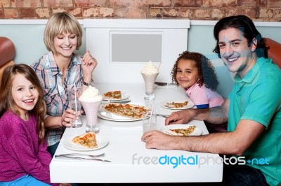 Family Eating Together In A Restaurant Stock Photo