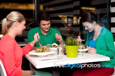 Family Enjoying Meal Outdoors Stock Photo