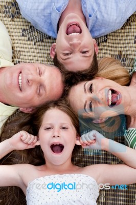 Family Members Lying On The Carpet Stock Photo