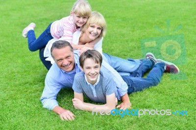 Family Of Four Having Fun Outdoors Stock Photo