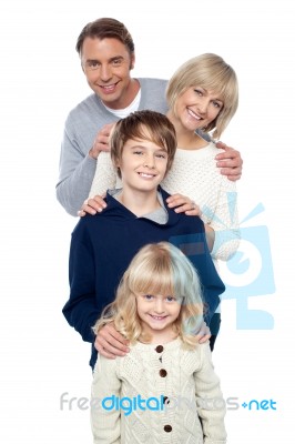 Family Of Four Posing In A Row Stock Photo