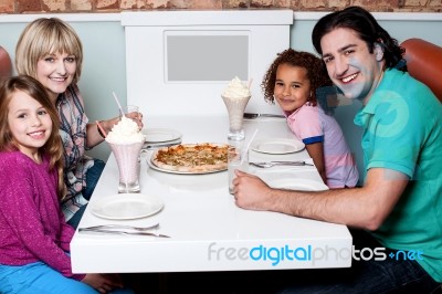 Family Of Four Posing To Camera Stock Photo