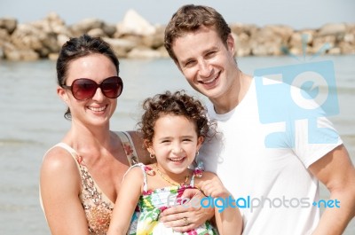 Family Of Three On The Beach Stock Photo