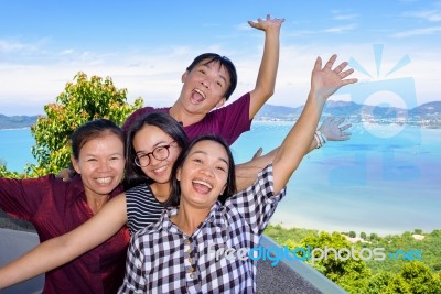 Family Of Tourists Inviting To See The Sea In Phuket, Thailand Stock Photo