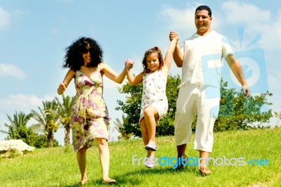 Family Playing With Daughter Stock Photo