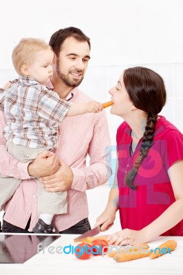 Family Preparing Food In The Kitchen Stock Photo