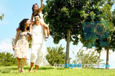 Family With Child On Shoulders Stock Photo