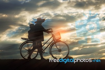 Farmer With Bicycle On A Field Stock Photo