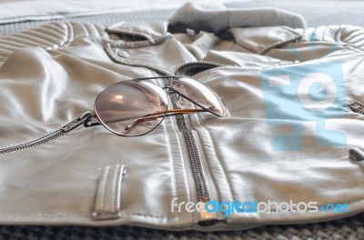 Fashion Sunglasses On Brown Jacket Stock Photo