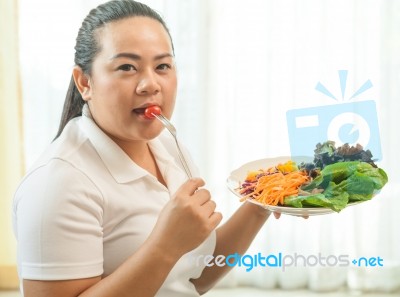 Fat Woman Eating Salad Stock Photo