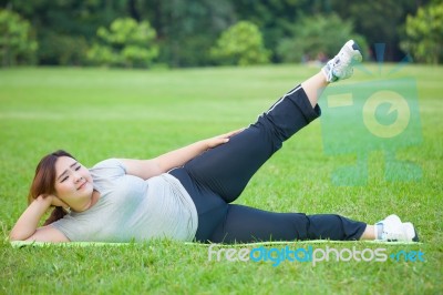 Fat Woman Lying By Exercise Leg Upwards Stock Photo