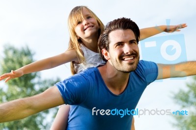 Father And Daughter Having Fun Outdoors Stock Photo