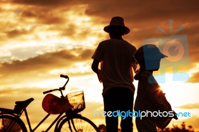 Father And Son At Sunset Stock Photo