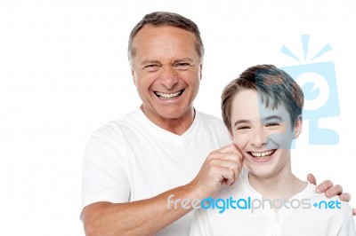 Father And Son Playing, Pinching Cheeks Stock Photo