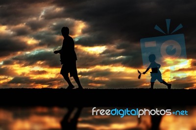 Father And Son Playing With Silhouettes Stock Photo