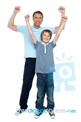 Father And Son Rejoicing Together Stock Photo